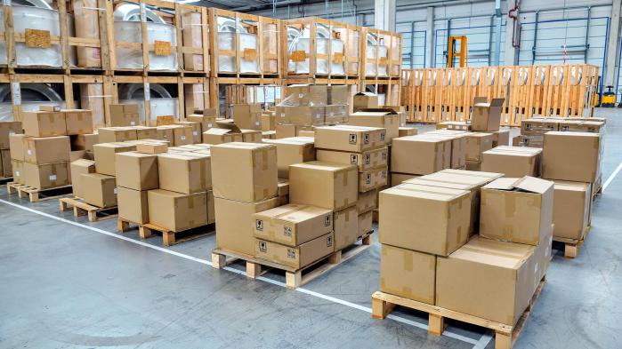 Stacked packages stand on pallets in a warehouse