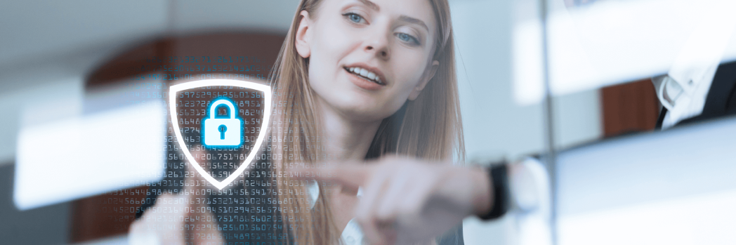 Blonde woman touches a lock icon on a glaswall in front of her with her finger.