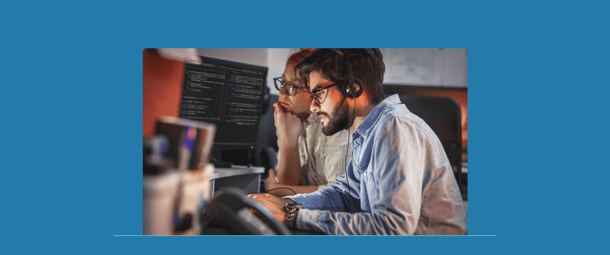 EIKONA is a managed services provider for logistics. Two people working together at one desk.