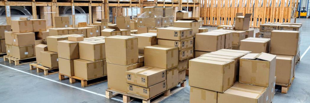 Stacked packages stand on pallets in a warehouse